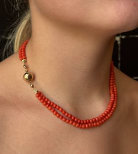 2-strengs vintage bloedkoraal bollen collier aan 14 karaats rosegouden antieke sluiting(13mm). Draaglengte van dit sieraad is 40cm, hoog in de hals te dragen, doorsnee kralen 5/5,5mm, totaalgewicht 27 gram. Slot gestempeld met het 585 goudmerk Hollands ge